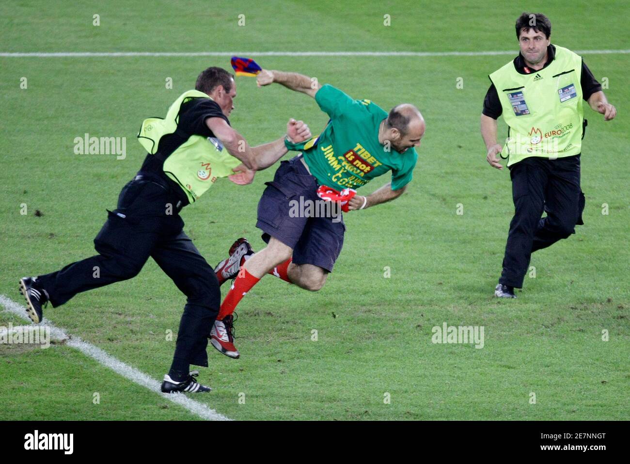 A pitch invader (C) is tackled by security staff during the Euro 2008 semi- final soccer match between Germany and Turkey at St Jakob Park stadium in  Basel, June 25, 2008. REUTERS/Ruben Sprich (