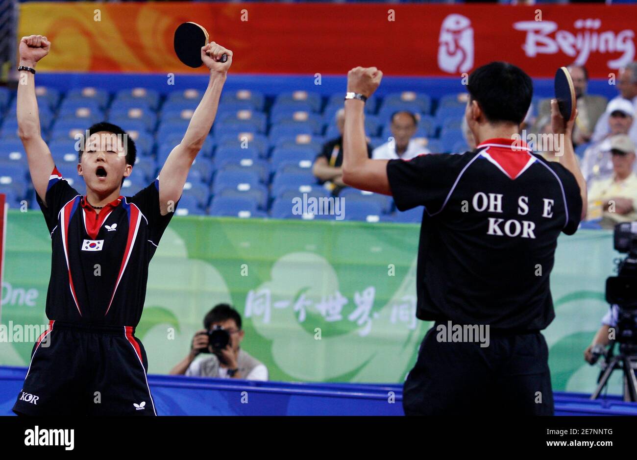 Yoon Jae-Young and Oh Sang-Eun (R) of South Korea celebrate winning their men's team bronze medal table tennis doubles match against Austria at the Beijing 2008 Olympic Games August 18, 2008.     REUTERS/Beawiharta (CHINA) Stock Photo
