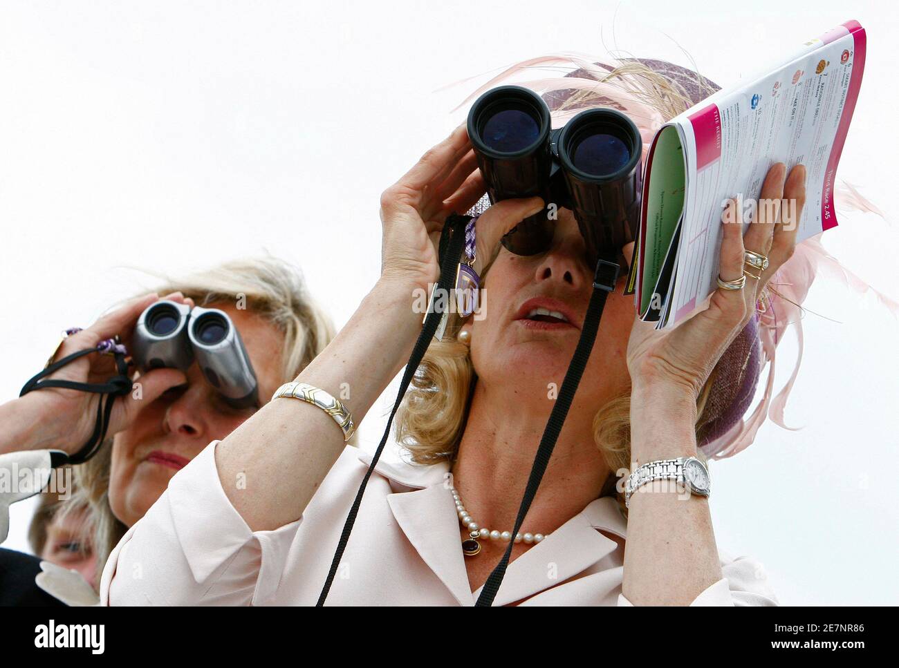 Racegoers watch the third race of the Epsom Derby Festival at Epsom Downs in Surrey, southern England June 6, 2008. REUTERS/Alessia Pierdomenico (BRITAIN) Stock Photo