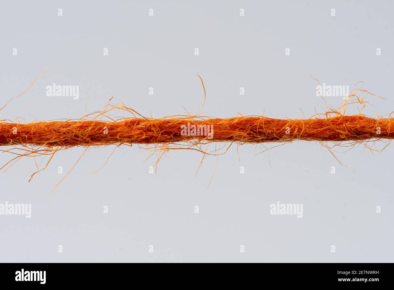red rope against white background Stock Photo - Alamy