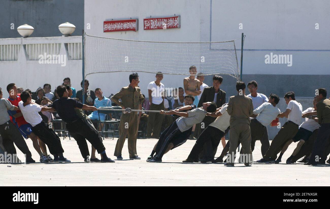 North Koreans participate in a tug-of-war on the bank of Yalu River near the North Korean town of Sinuiju September 9, 2009. September 9 marks the 61st anniversary of the founding of North Korea.  REUTERS/Jacky Chen (NORTH KOREA SOCIETY) Stock Photo