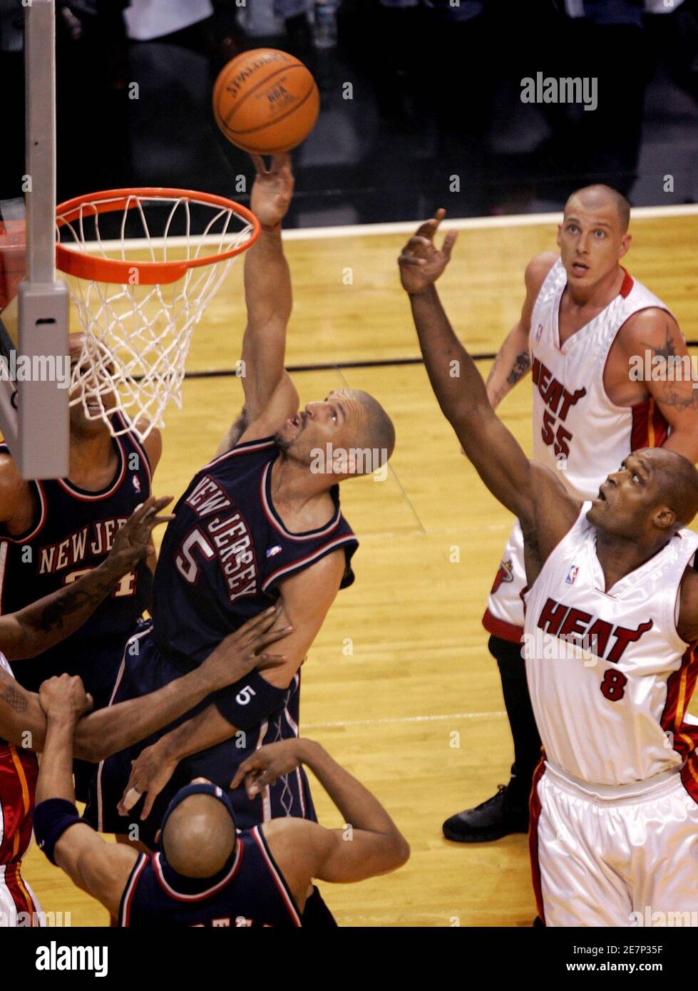 New Jersey Nets Jason Kidd (5) scores as Miami Heat Antoine Walker (8) and Jason  Williams watches during the first half of Game 2 of their second round NBA  basketball playoff series