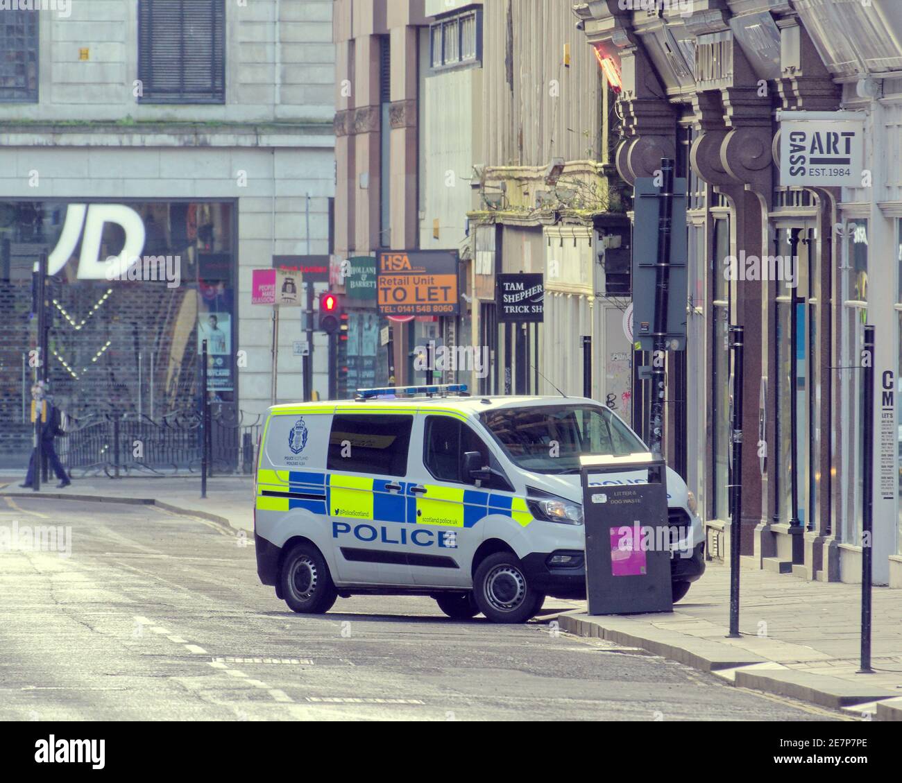 Glasgow, Scotland, UK.30th January, 2021, Lockdown Saturday and police attend an incident behind princes square   Springfield Court breah in on queen streeet  misery continues at least the rain stopped as  deserted streets in the town centre shopping areas relies in posters and wall art as a substitute for life. Credit Gerard Ferry/Alamy Live News Stock Photo