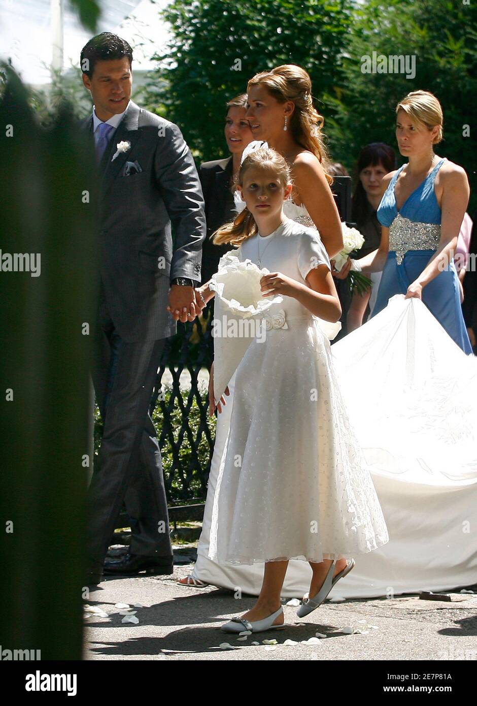 German national soccer player Michael Ballack and his new wife Simone Lambe  walk through the Bavarian Yacht Club after their religious wedding ceremony  at lake Starnberg in Starnberg July 15, 2008. The