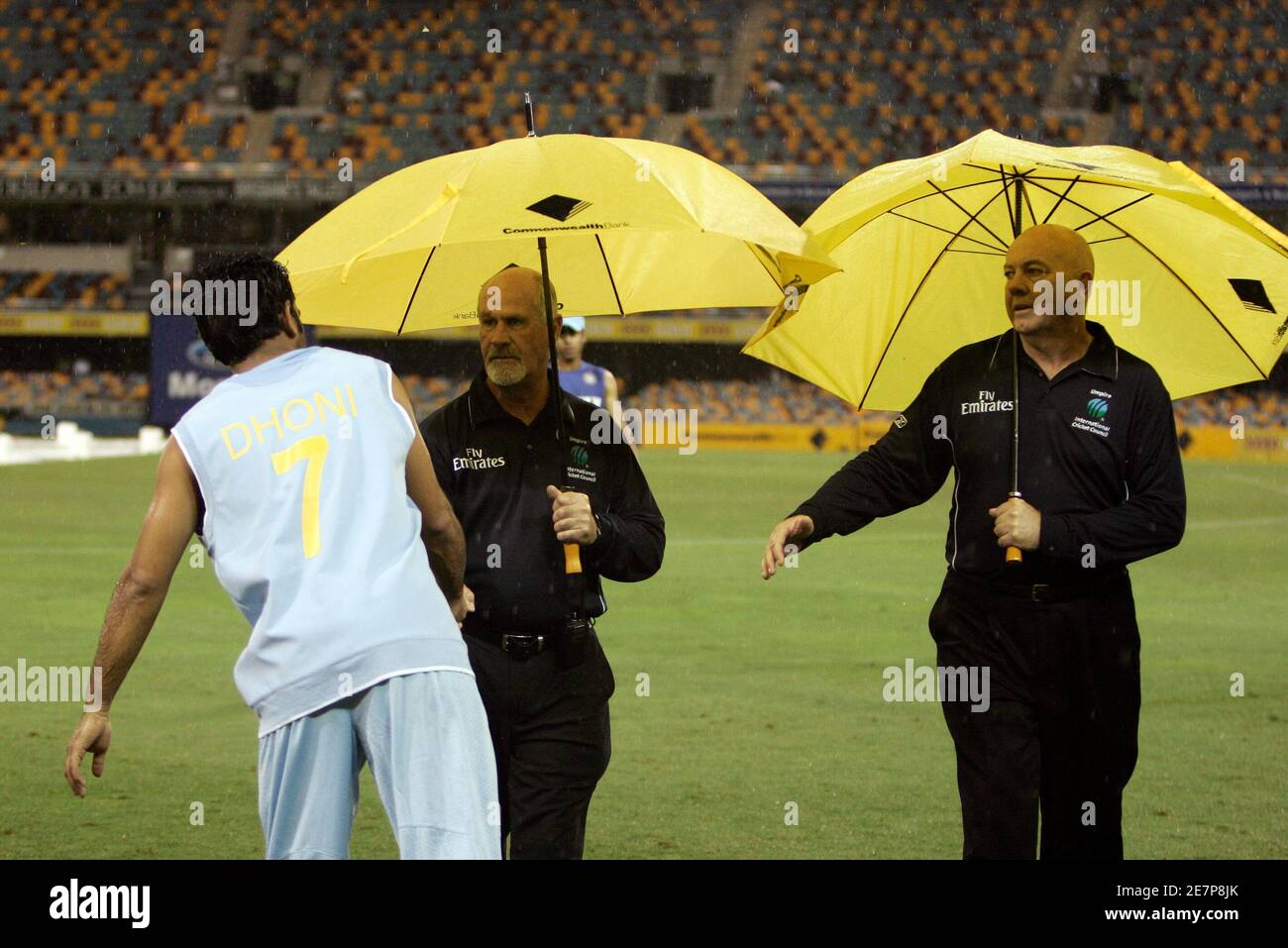 Umpires Steve Davis (R) and Rudi Koertzen (C) shake hands with India's Mahendra Singh Dhoni after play was called off because of rain at the tri-series one-day international cricket match against Sri Lanka in Brisbane February 5, 2008.  REUTERS/Steve Holland (AUSTRALIA) Stock Photo