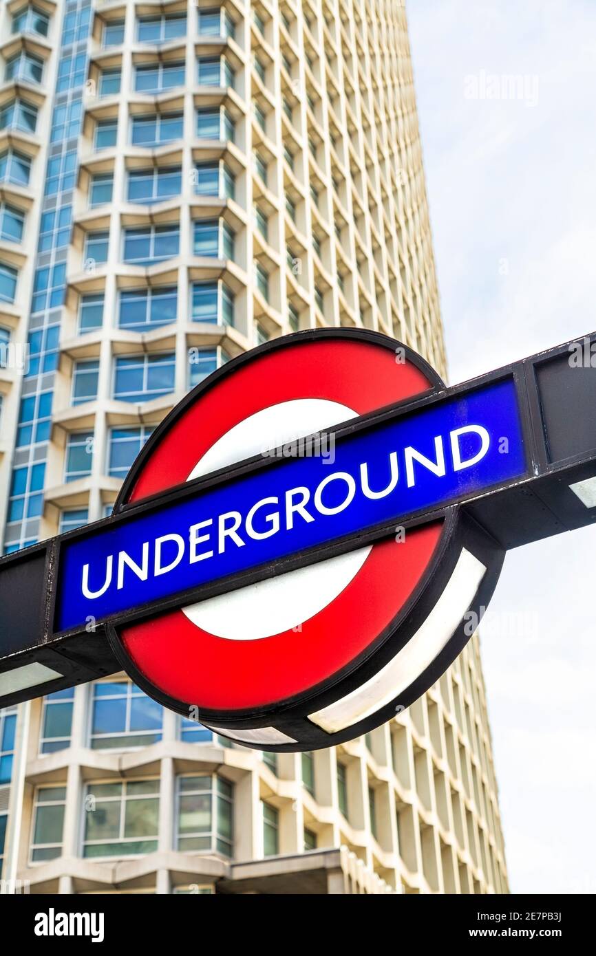 London Underground sign at Tottenham Court Road tube station with Centre Point skyscraper in the background, London, UK Stock Photo