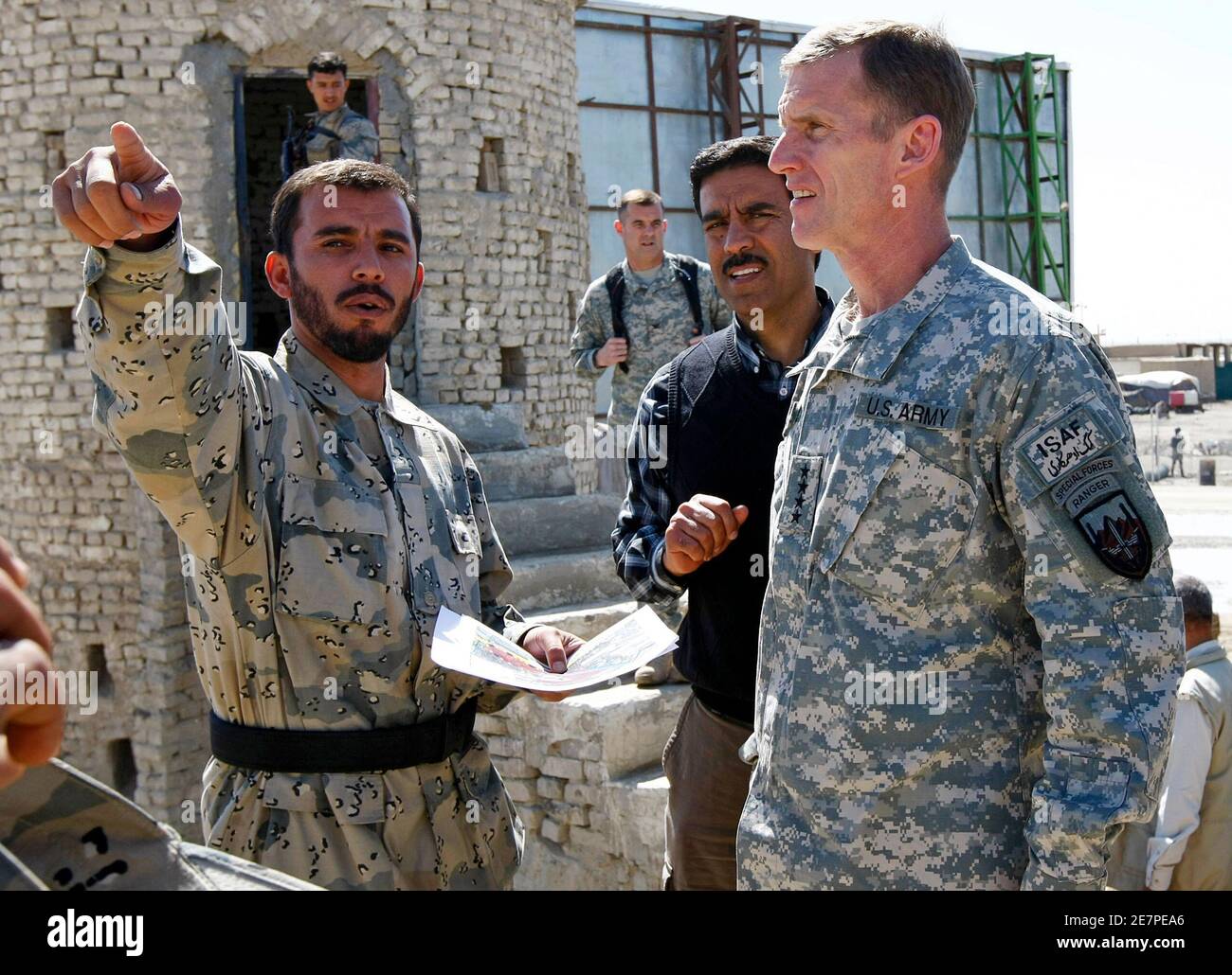 General Stanley McChrystal (R), commander of U.S. and NATO forces in Afghanistan, receives a briefing from Afghan border police commander Colonel Abdul Razziq during a visit to the Afghan border with Pakistan, near Spin Boldak in Kandahar Province, southern Afghanistan, in this March 4, 2010 file photo. One of the most important trade routes in Asia was closed last week while a boyish-looking man everyone calls "the general" showed around the commander of U.S. and NATO forces in Afghanistan. Picture taken March 4, 2010.   To match feature AFGHANISTAN-BORDER/     REUTERS/Peter Graff  (AFGHANIST Stock Photo