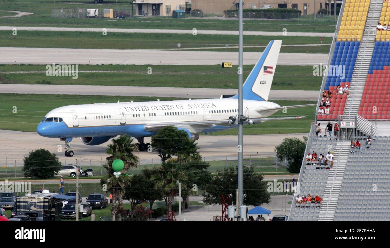 Air Force Two with Vice President Dick Cheney lands at the Daytona International Airport as race fans in the back stretch grandstands watch the pre-race activities at the Daytona International Speedway in Daytona Beach, Florida on July 1, 2006. REUTERS/Rick Fowler (United States) Stock Photo