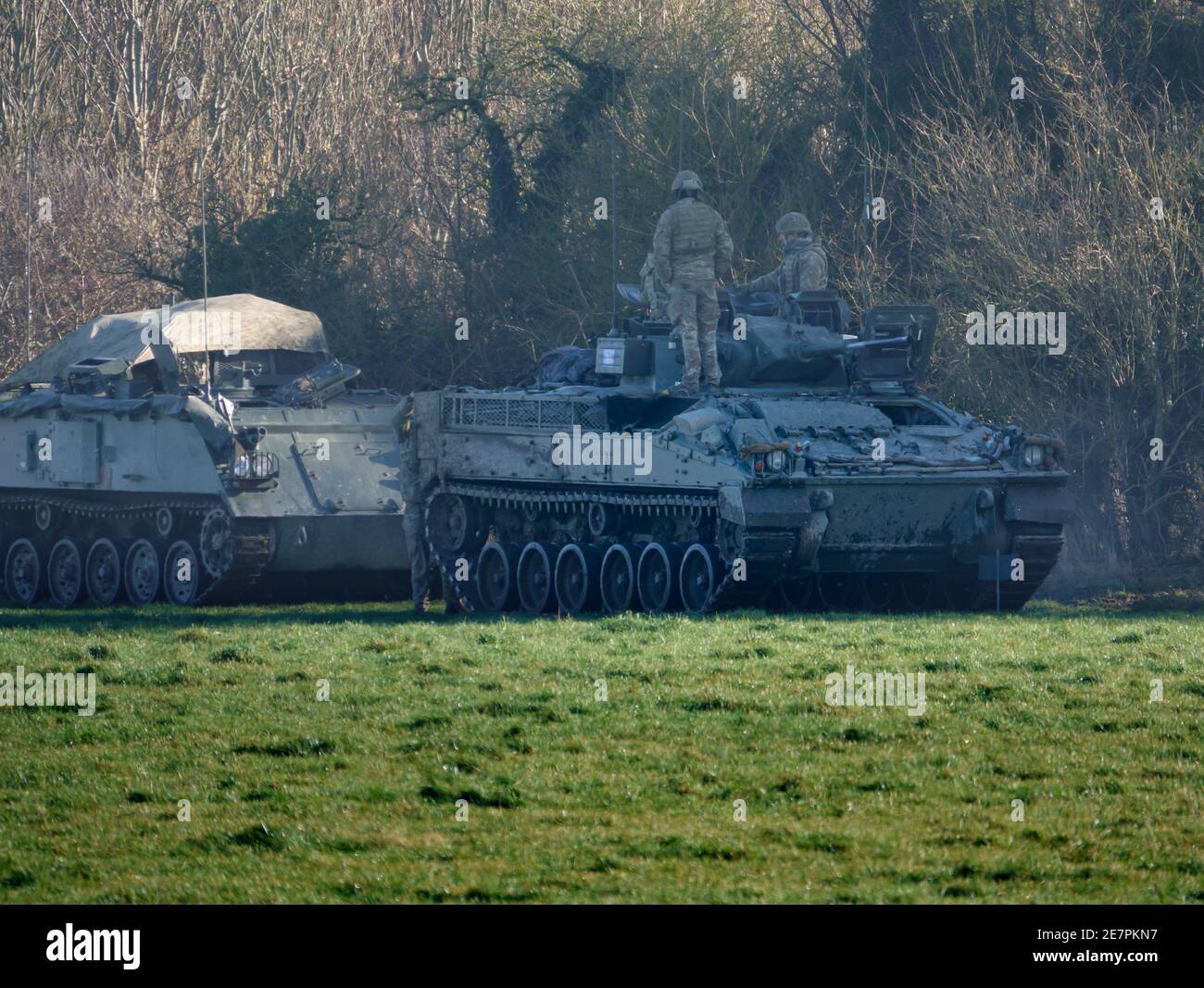 british army warrior tank with crew and auxilliary FV403 tracked armoured vehicle preparing for