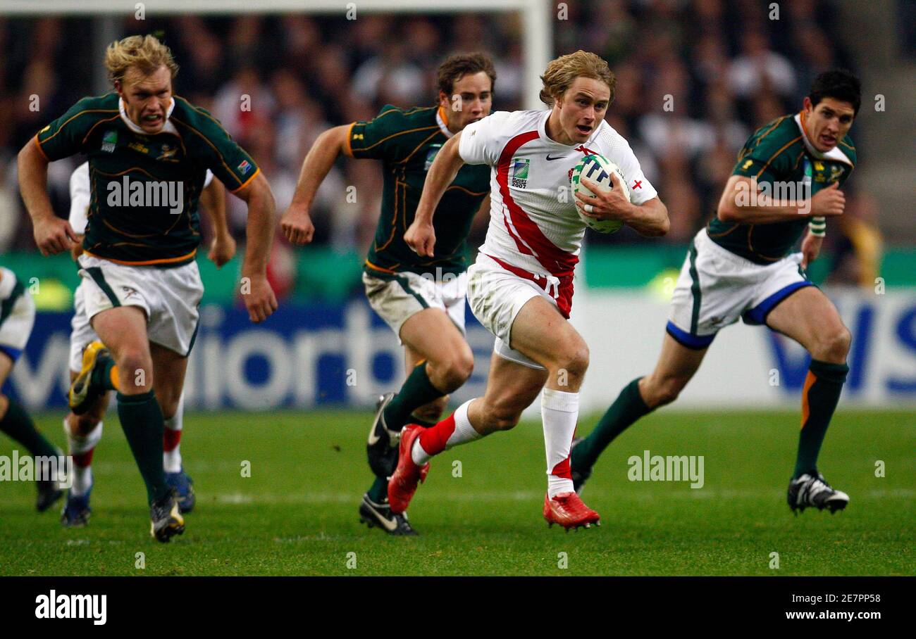 England's Mathew Tait (2nd R) runs past South Africa's Schalk Burger (L), Butch James (2nd L) and Jaque Fourie during the Rugby World Cup final at the Stade de France in Saint-Denis, near Paris October 20, 2007.    REUTERS/Eddie Keogh (FRANCE) Stock Photo