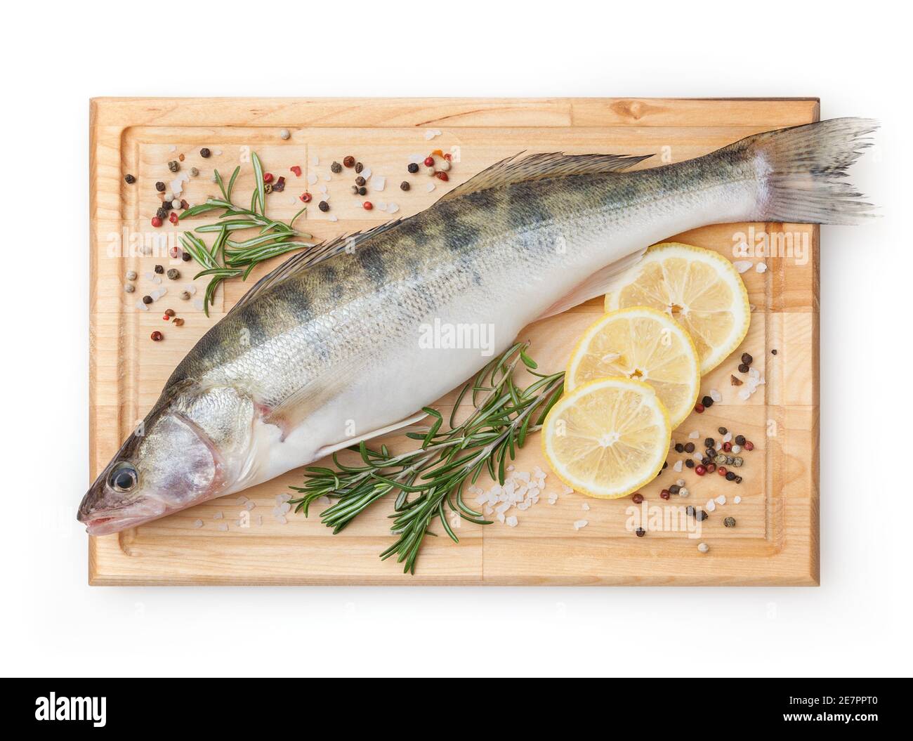 Fresh uncooked pike perch with lemon, rosemary and spice on wooden board isolated on white background with clipping path Stock Photo