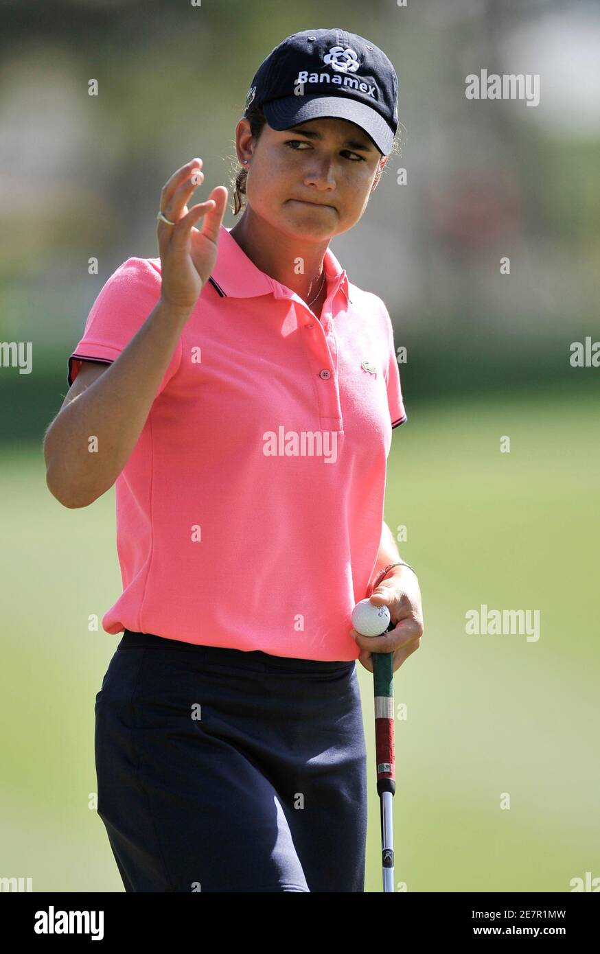 Lorena Ochoa of Mexico waves to the crowd as she putts out on the first hole during final round play of the LPGA's Kraft Nabisco Championship golf tournament in Rancho Mirage, California, April 4, 2010.  REUTERS/Gus Ruelas (UNITED STATES - Tags: SPORT GOLF) Stock Photo