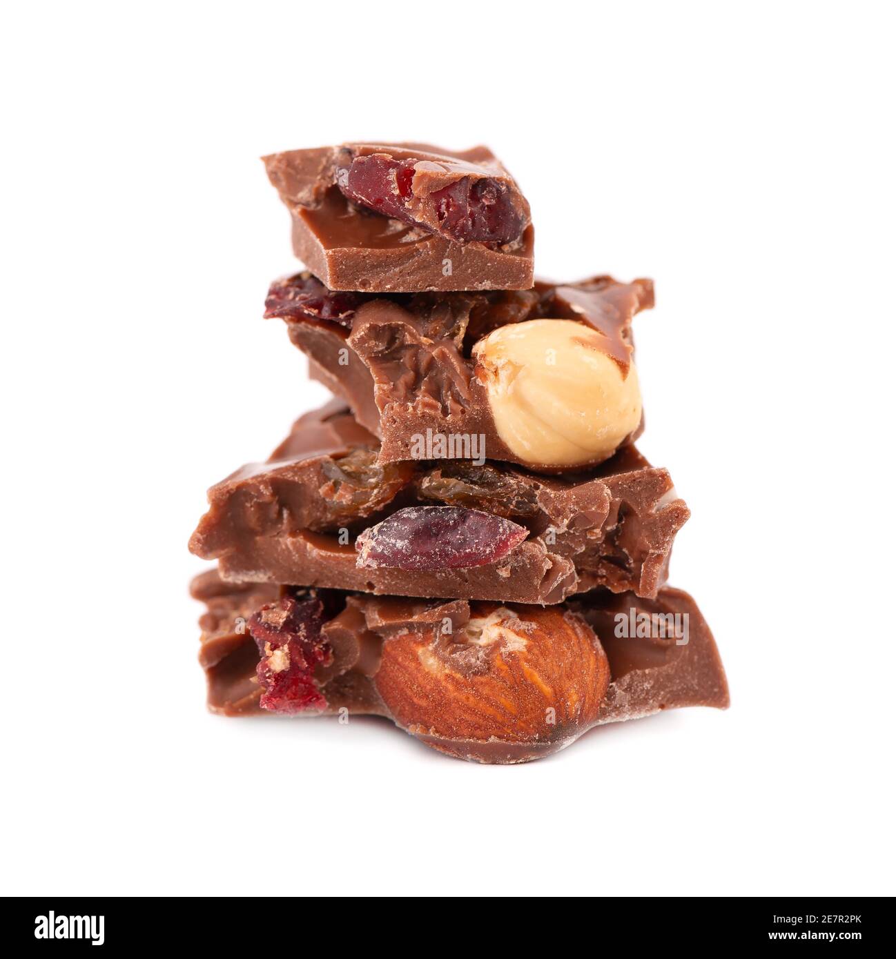 Chocolate pieces stack with nuts and berries, isolated on white background. Close up Stock Photo