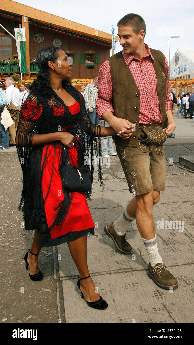 Bayern Munich's midfielder Sebastian Deisler arrives with his wife Eunice  at the world biggest beer festival the Oktoberfest in Munich October 1,  2006. Germans, in party mood after the World Cup and