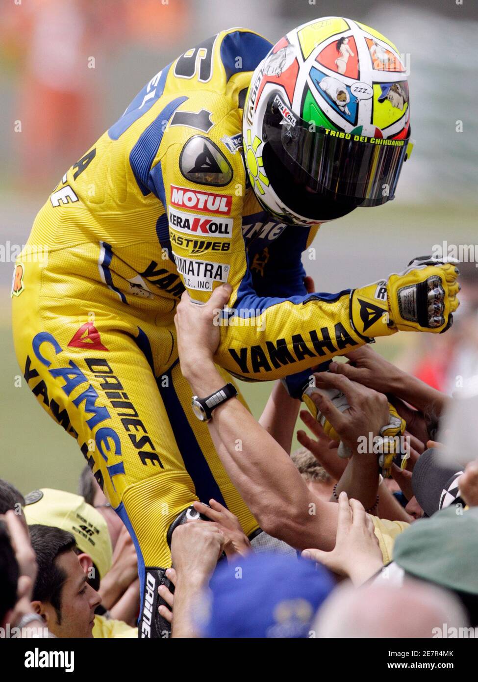 Yamaha MotoGP rider Valentino Rossi of Italy celebrates with fans after winning the Italian Motorcycling Prix on circuit central Italy June 4, 2006. REUTERS/Chris Helgren (ITALY Stock Photo - Alamy