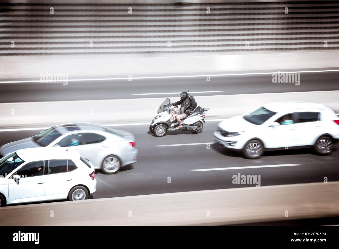 Touring car and motorcycle sweeping at speed in the city. Transportation concept. Stock Photo