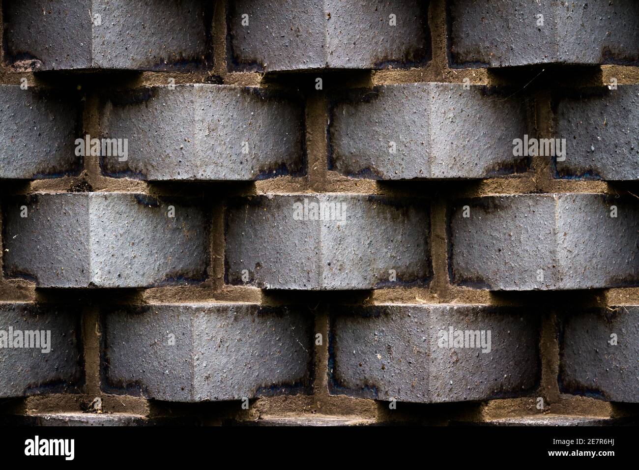 Dark bricks forming a wall set in an unusual angle Stock Photo