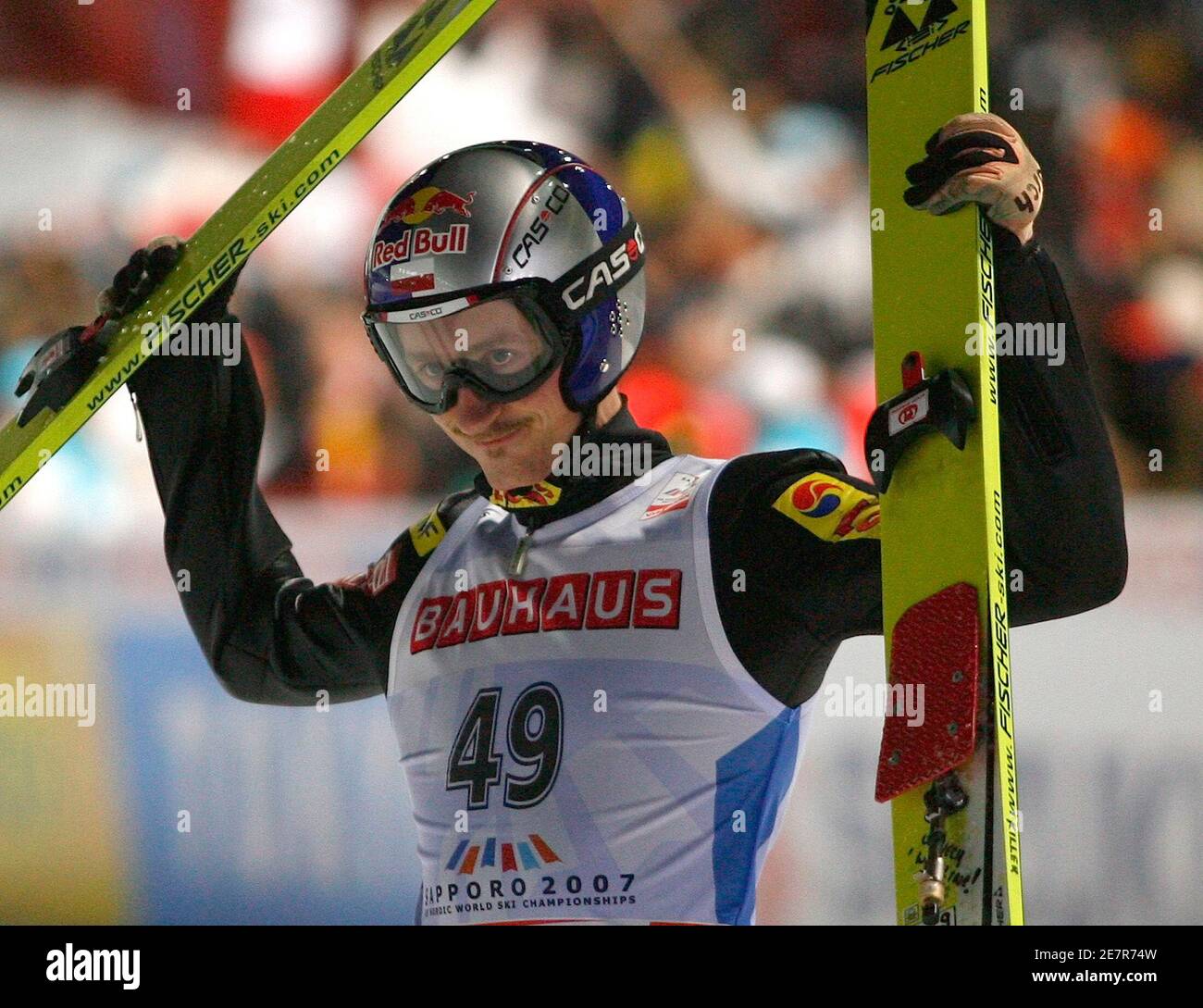 Poland's Adam Malysz celebrates after the final jump of the normal hill