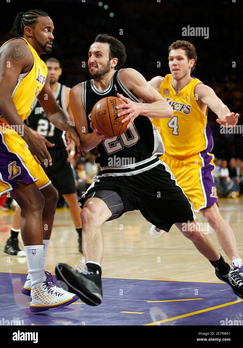 San Antonio Spurs Manu Ginobili (C) drives to the basket past Los Angeles Lakers Luke Walton (R) and Ronny Turiaf (L) during Game 5 of their NBA Western Conference final basketball playoff series in Los Angeles, May 29, 2008.     REUTERS/Gus Ruelas (UNITED STATES) Stock Photo