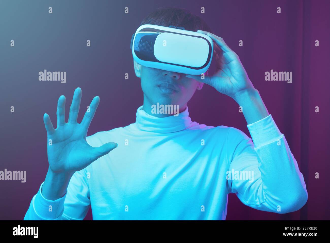 Young asian man wearing virtual reality goggles watching 360 degree video  in neon light, Technology concept Stock Photo - Alamy