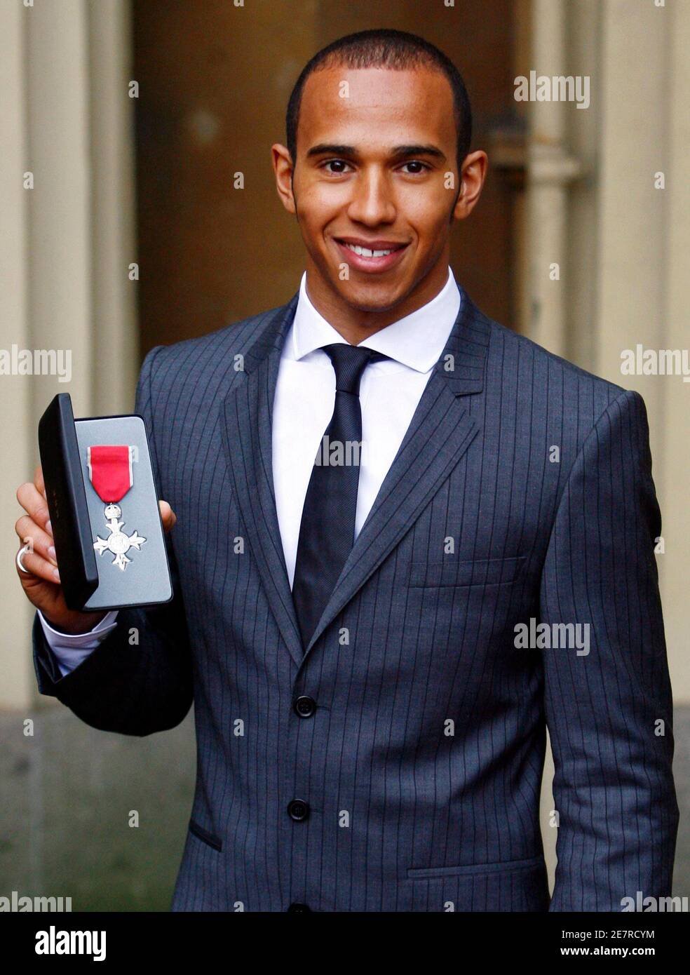Formula One world champion Lewis Hamilton shows the MBE he received from Britain's  Queen Elizabeth II at Buckingham Palace, London, March 10, 2009.  REUTERS/Johnny Green/Pool (BRITAIN SPORT MOTOR RACING ROYALS Stock Photo -