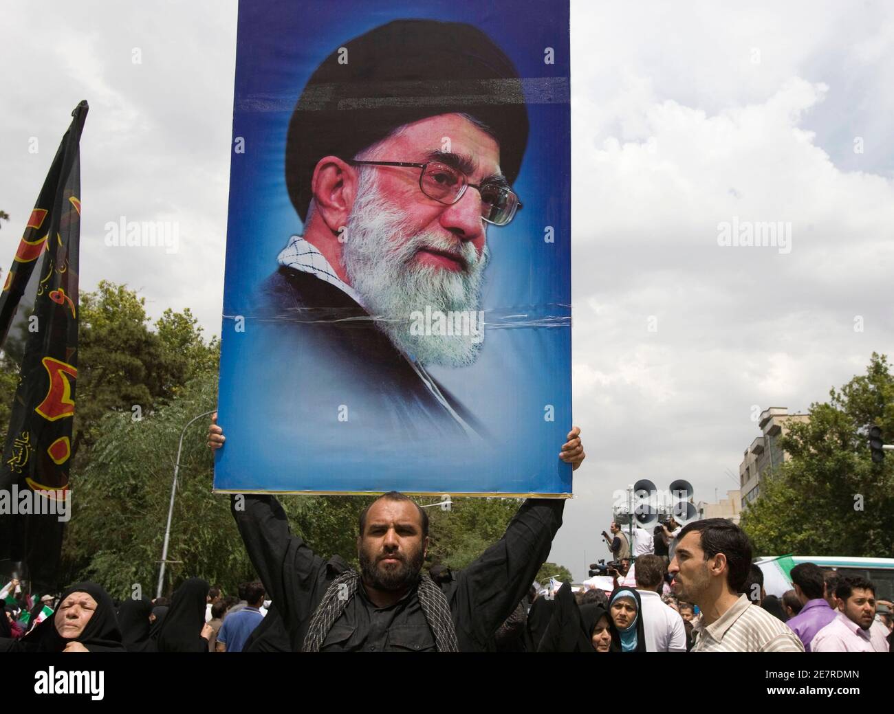 EDITORS' NOTE: Reuters and other foreign media are subject to Iranian restrictions on their ability to report, film or take pictures in Tehran.  A worshiper holds a picture of Iran's supreme leader Ayatollah Ali Khamenei after Friday prayers in Tehran June 19. 2009. Khamenei on Friday demanded an end to street protests that have shaken the country since a disputed presidential election a week ago and said any bloodshed would be their leaders' fault.  REUTERS/Raheb Homavandi (IRAN CONFLICT POLITICS ELECTIONS RELIGION) Stock Photo