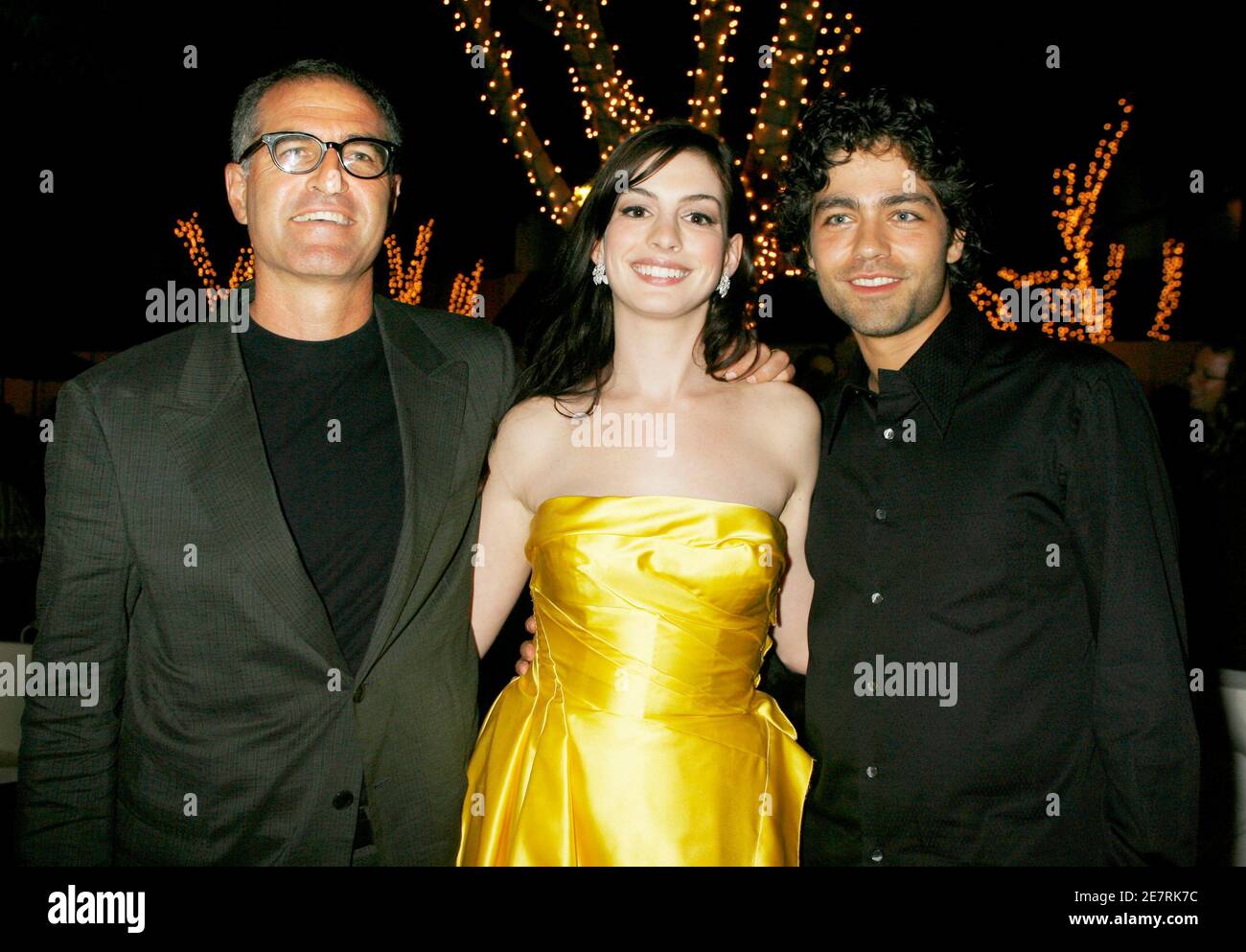 Actors Anne Hathaway (C) and Adrian Grenier, stars of the film 'The Devil Wears Prada', pose with the film's director David Frankel (L) at the party after the screening of the film at the opening night of the Los Angeles Film Festival in Los Angeles June 22, 2006.[The film is set in the world of a high powered fashion magazine.] Stock Photo