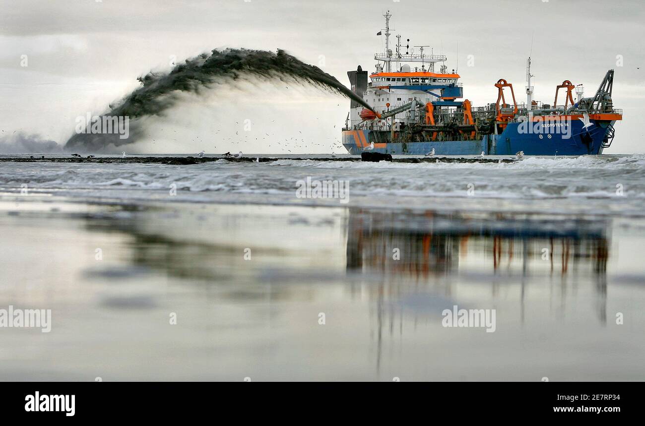 A dredging boat of the Van Oord company sprays sand at the shore of Den Helder November 27, 2007. The Netherlands, world leaders in land reclamation, are considering an island in the shape of a tulip to fight overcrowding and shield the coastline from the rising sea. Picture taken November 27, 2007. To match feature DUTCH ISLAND REUTERS/Koen van Weel (NETHERLANDS) Stock Photo