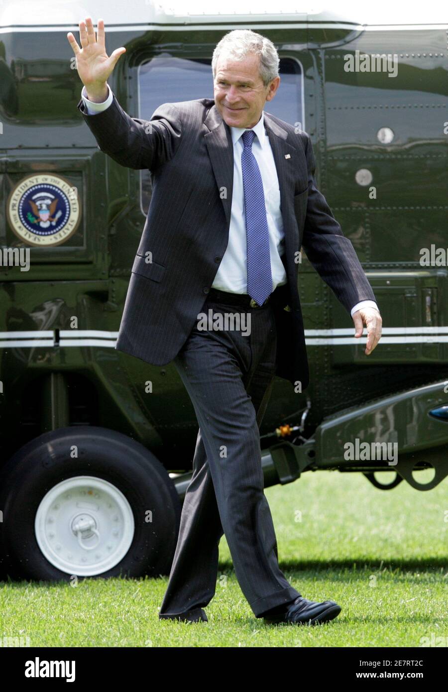 U.S. President George W. Bush waves as he walks on the South Lawn of the White House upon his return to Washington July 4, 2008. Bush attended Monticello?s annual Independence Day celebration and naturalization ceremony in Charlottesville, Virginia. REUTERS/Yuri Gripas (UNITED STATES) Stock Photo
