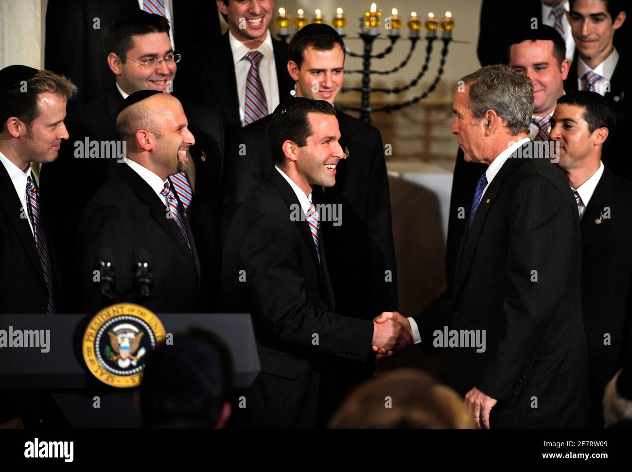 U.S. President George W. Bush greets members of Kol Zimra, a Jewish choir, after they performed for a Hanukkah event at the White House in Washington December 15, 2008. REUTERS/Mike Theiler  (UNITED STATES) Stock Photo