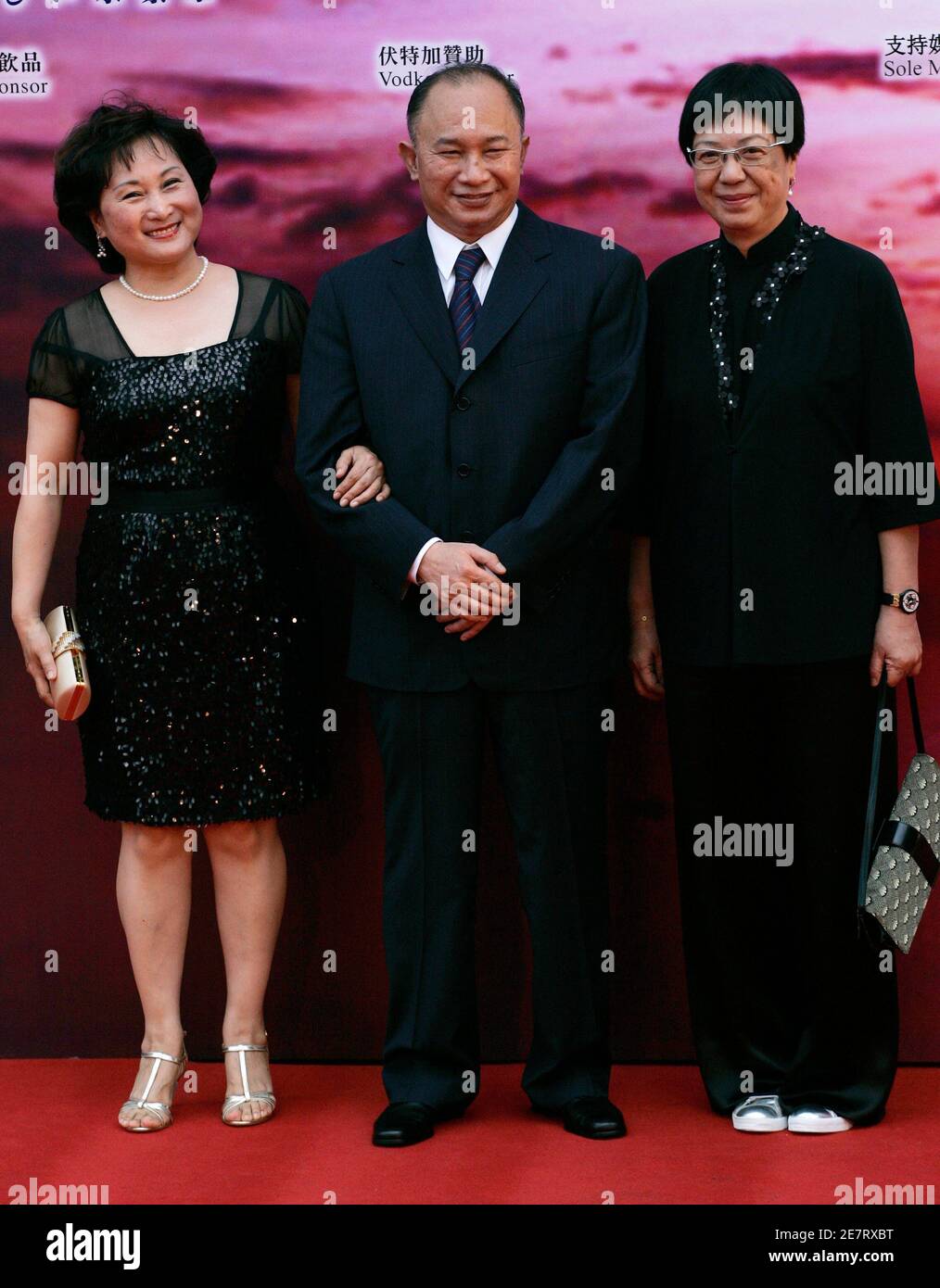 Hong Kong director John Woo (C), his wife Annie and Hong Kong director Ann Hui (R) arrive at the Hong Kong Film Awards April 19, 2009.   REUTERS/Tyrone Siu   (CHINA ENTERTAINMENT) Stock Photo