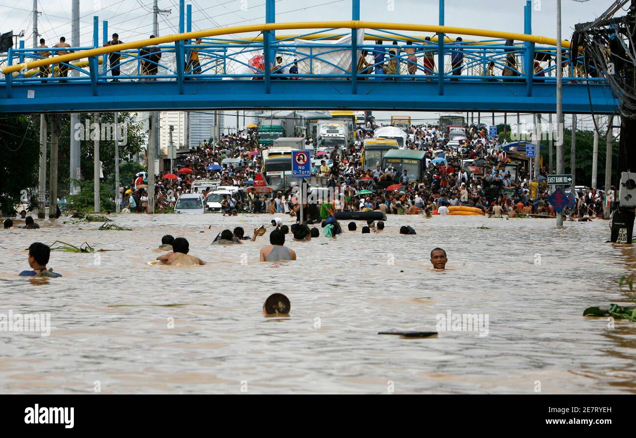 Residents swim towards high ground during flooding caused by Typhoon