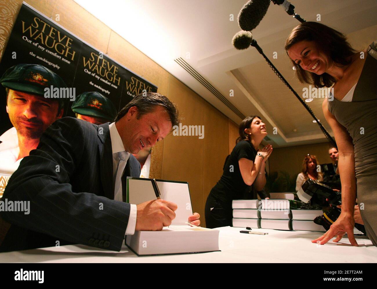 Former Australian cricket team captain Steve Waugh signs a copy of his autobiography for a cricket fan in Sydney October 23, 2005. Waugh, Australia's Test cricket captain from 1999 to 2004, has penned a book entitled "Out of My Comfort Zone" in which he reveals insights into life on and off the field during the time he headed a dominant team. REUTERS/Will Burgess Stock Photo
