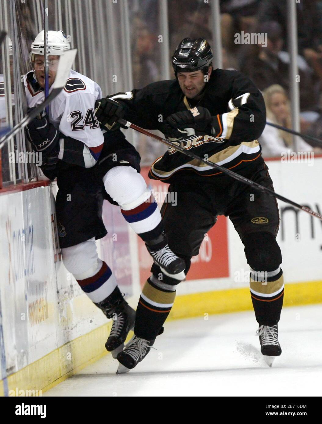 Vancouver Canucks' Matt Cooke (L) gets checked by Anaheim Ducks' Dustin Penner during the first period of their NHL hockey game in Anaheim March 11, 2007. REUTERS/Gus Ruelas (UNITED STATES) Stock Photo