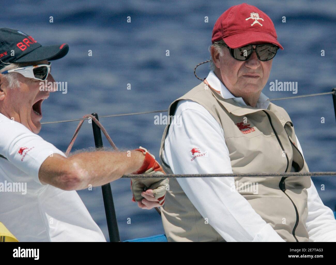 Spain's King Juan Carlos (R) sits next to his crew mate Jose Cusi aboard  the yacht 
