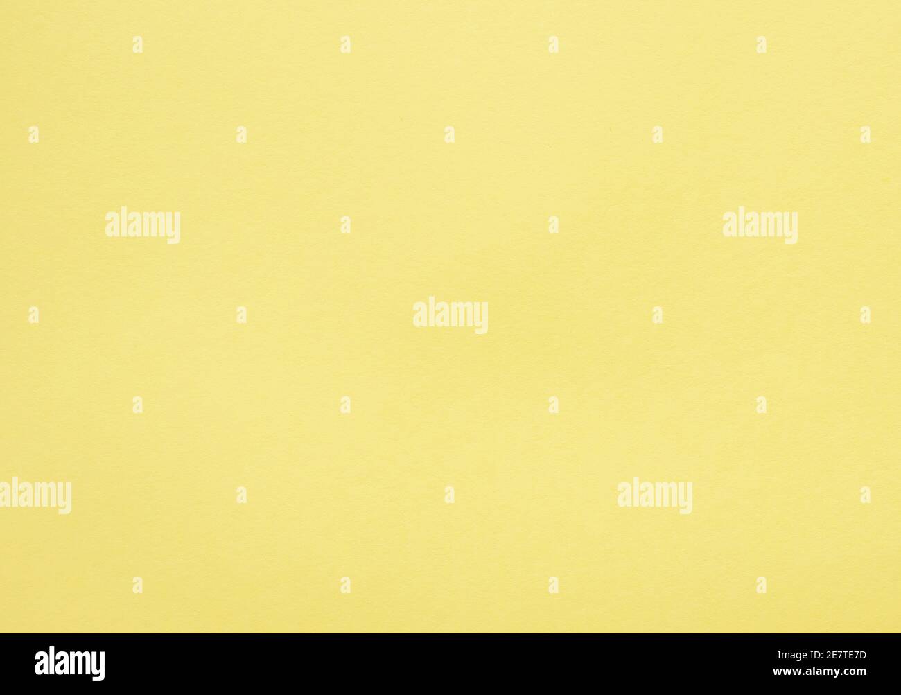 Yellow colored tinted paper sheet background. Stock Photo