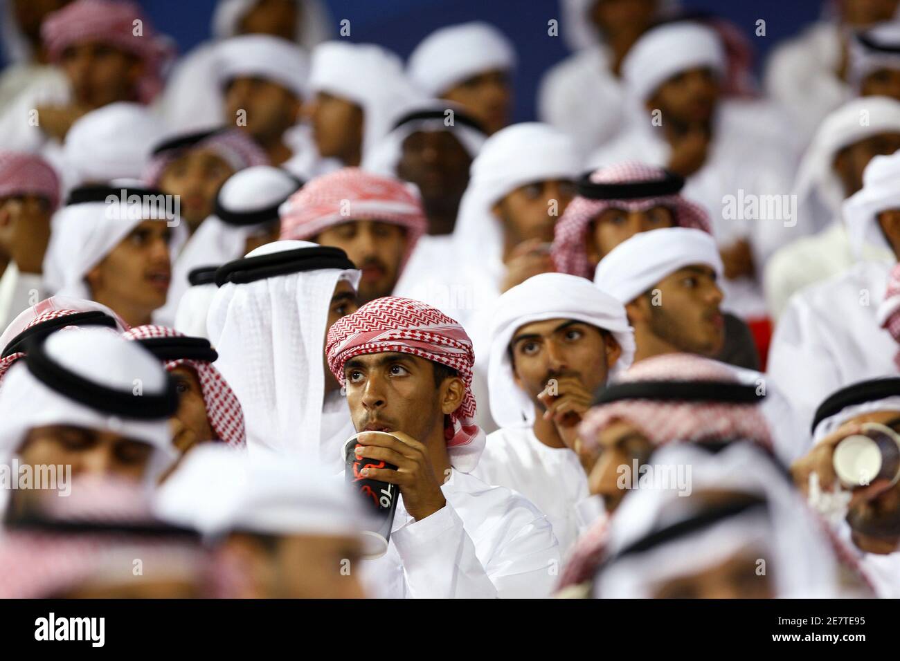Fans sit in the stands during the FIFA Club World Cup soccer match between TP Mazembe and Pohang Steelers at Mohammad Bin Zayed stadium in Abu Dhabi December 11, 2009. REUTERS/Fahad Shadeed (UNITED ARAB EMIRATES SPORT SOCCER) Stock Photo