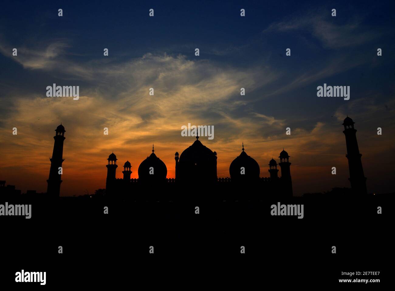 An attractive significant stunning view of the clouds hovering on the sky over historical Badshahi Mosque during sunset in Lahore Stock Photo