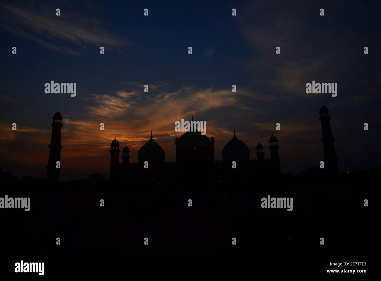 An attractive significant stunning view of the clouds hovering on the sky over historical Badshahi Mosque during sunset in Lahore Stock Photo
