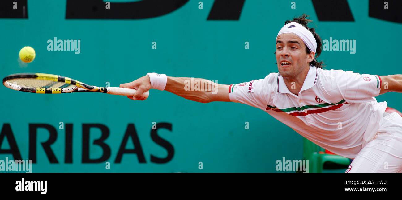 Pere Riba of Spain returns the ball to Marc Gicquel of France during the  French Open