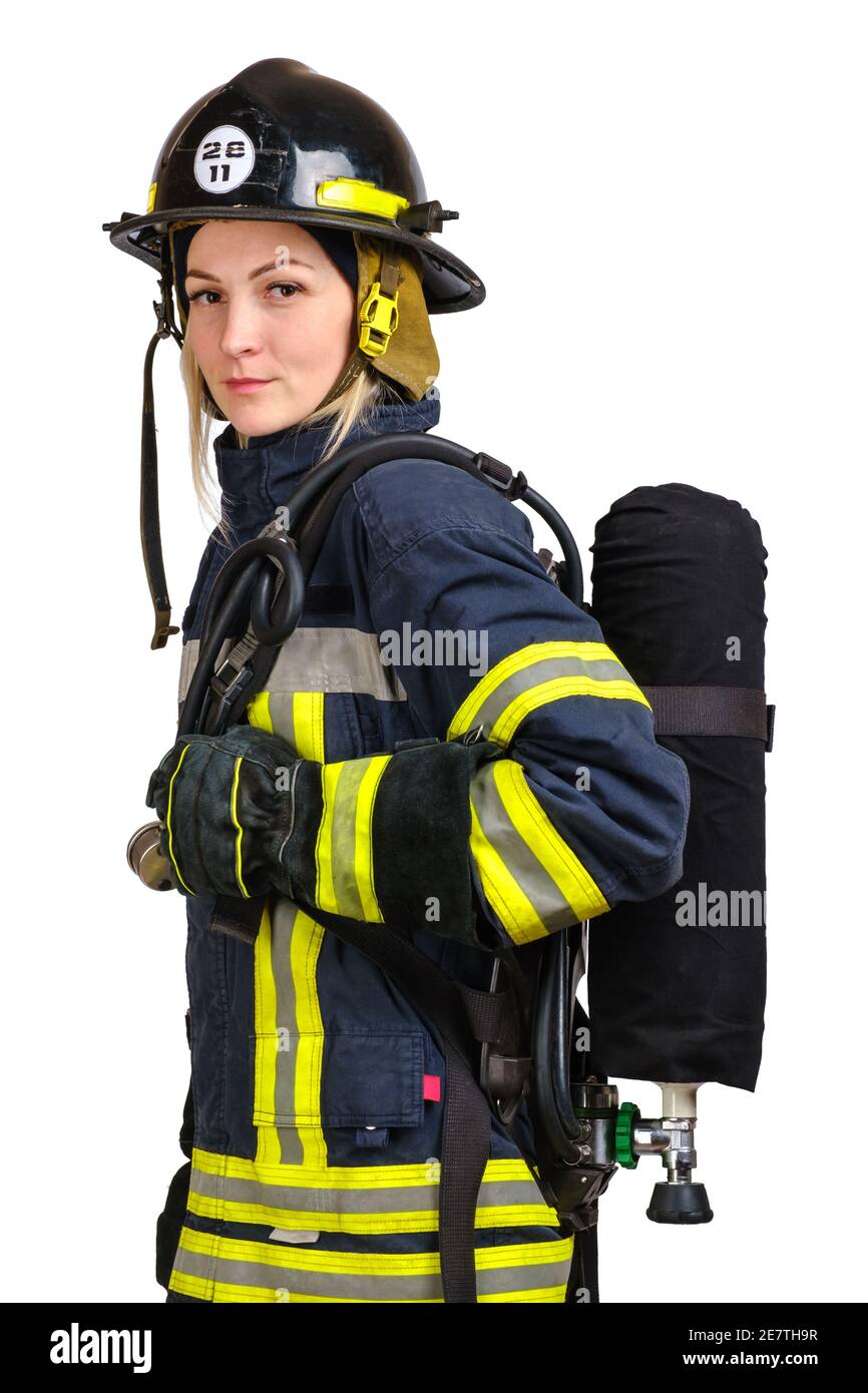 Woman in uniform of firefighter posing in profile with air tank Stock Photo