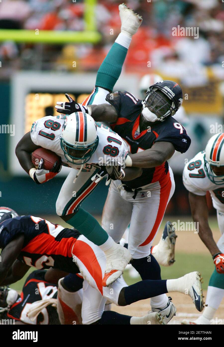 Miami Dolphins Tight End Randy Mcmichael C Goes Up And Over Denver Broncos Defender Ebenezer Ekuban R During The Second Quarter Of Their Game In Miami Florida September 11 2005 Reuters Marc Serota