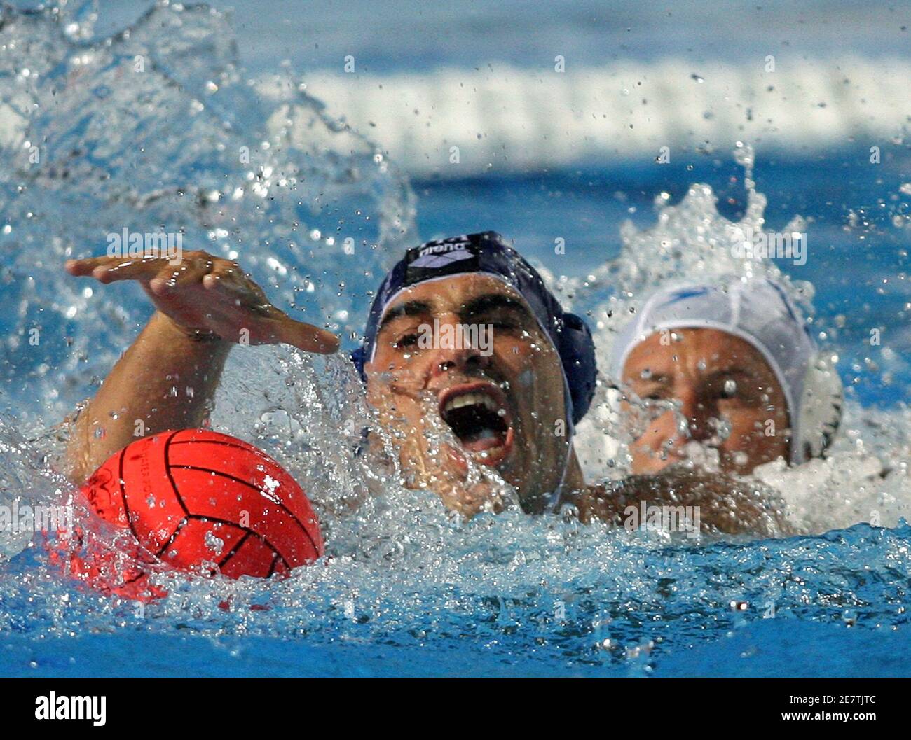 Italy's Alessandro Calcaterra (L) struggles for the ball with Romania's  Alexandru Matei during their quarterfinal match at the water polo European  Championships in Belgrade September 7, 2006. REUTERS/Ivan Milutinovic  (SERBIA Stock Photo -