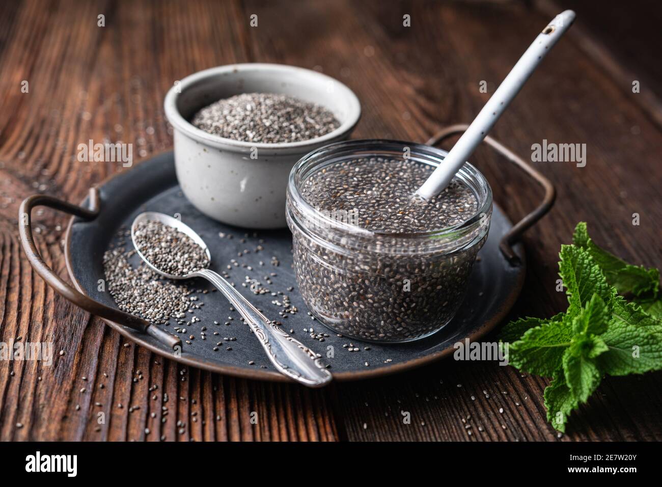 Easy to digest chia seed gel rich in calcium and dietary fiber in a glass jar on rustic wooden background Stock Photo