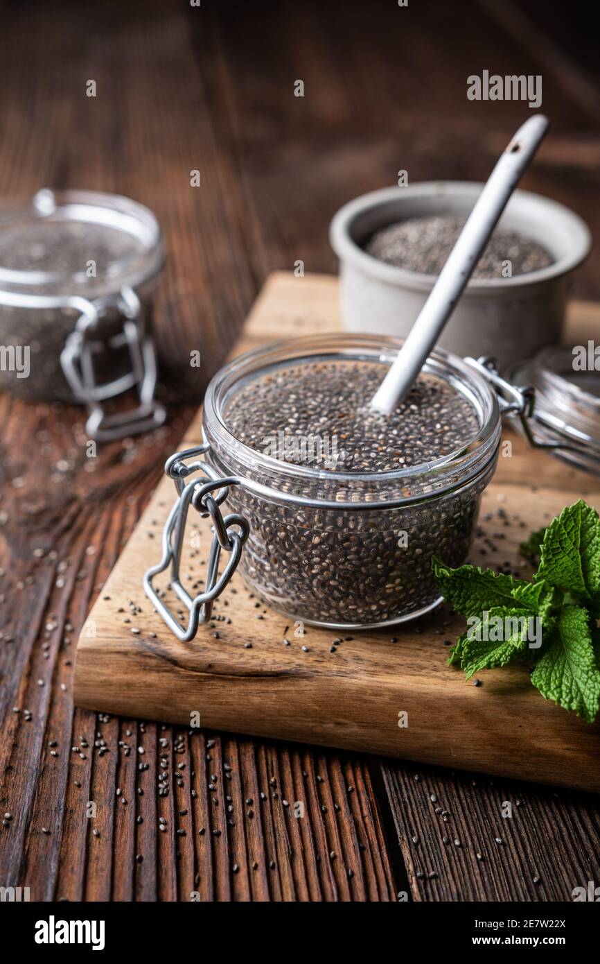 Easy to digest chia seed gel rich in calcium and dietary fiber in a glass jar on rustic wooden background Stock Photo