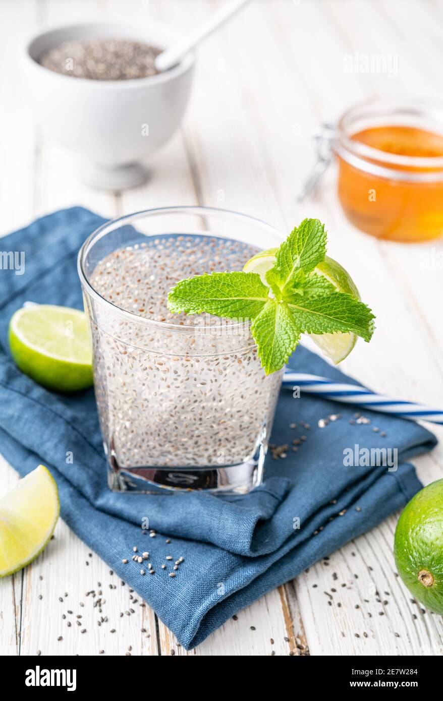 Mexican Energizing drink, Chia Fresca made from water, seeds, lime and sweetened with honey on rustic white wooden background Stock Photo