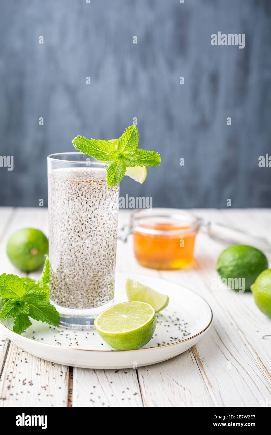 Mexican Energizing drink, Chia Fresca made from water, seeds, lime and sweetened with honey on rustic white wooden background with copy space Stock Photo