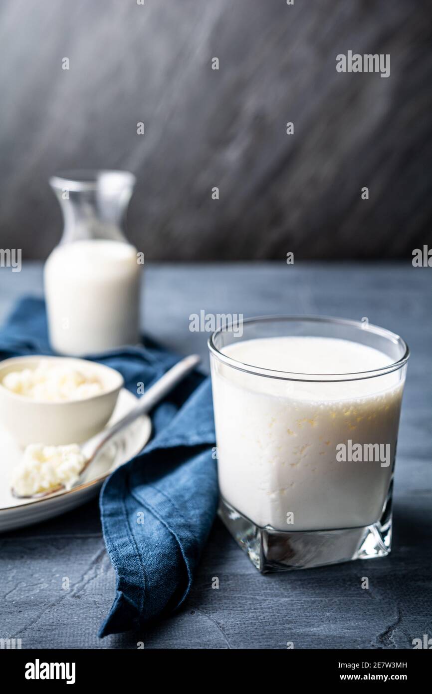 Homemade healthy fermented probiotic drink for digestion and gut health, Kefir in a glass jar with milk kefir grains with copy space Stock Photo