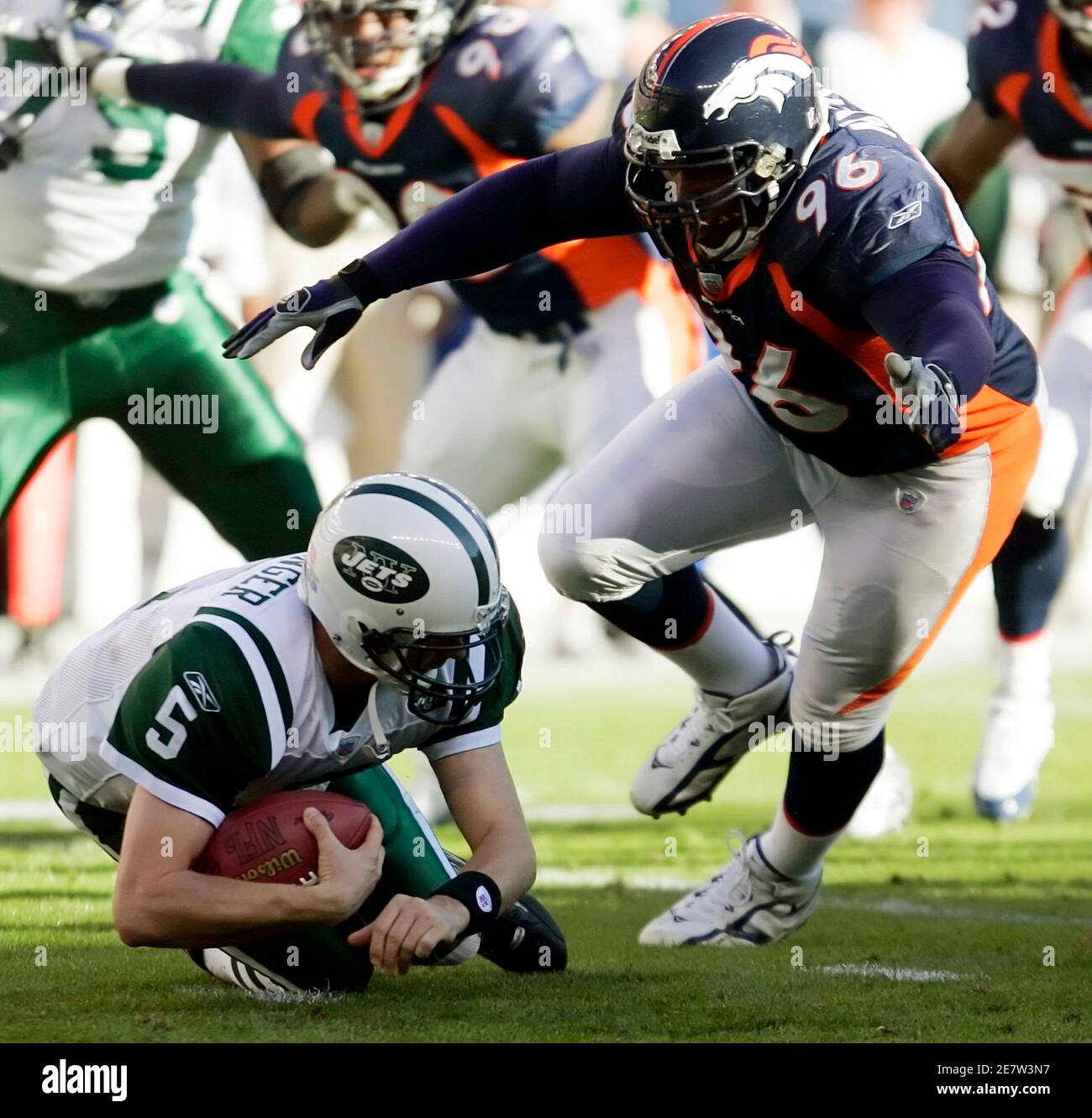 New York Jets quarterback Brooks Bollinger (L) is sacked after he fell down by Denver Broncos defensive tackle Michael Myers in the first quarter in Denver November 20, 2005. REUTERS/Rick Wilking Stock Photo