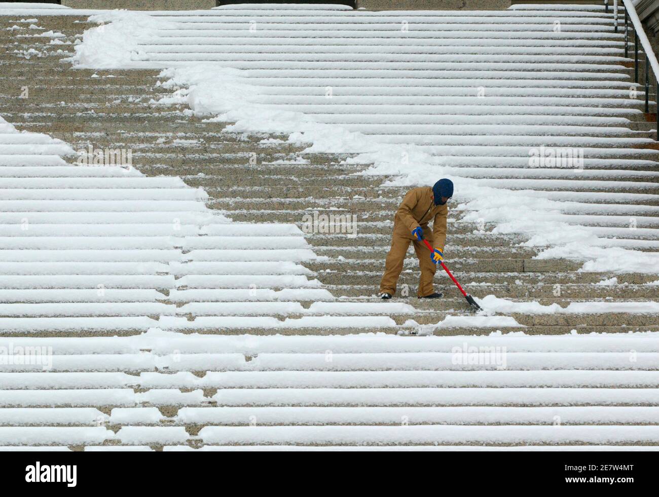 Willie Simmons shovels the numerous steps of the National Archives after a major snowstorm hit the Washington area on February 12, 2006. Airports from Washington to Boston are shut down due to high, gusting winds and major accumulations of snow.        REUTERS/Gary Cameron Stock Photo